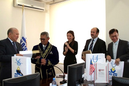Exchanging gifts at the Kazakh's National Technical University (KazNTU). UPM's Vice Chancellor (second from left) is wearing the ceremonial guest of honour robe presented by the Rector of KazNTU, Professor Jeksenbek Adilov (left).